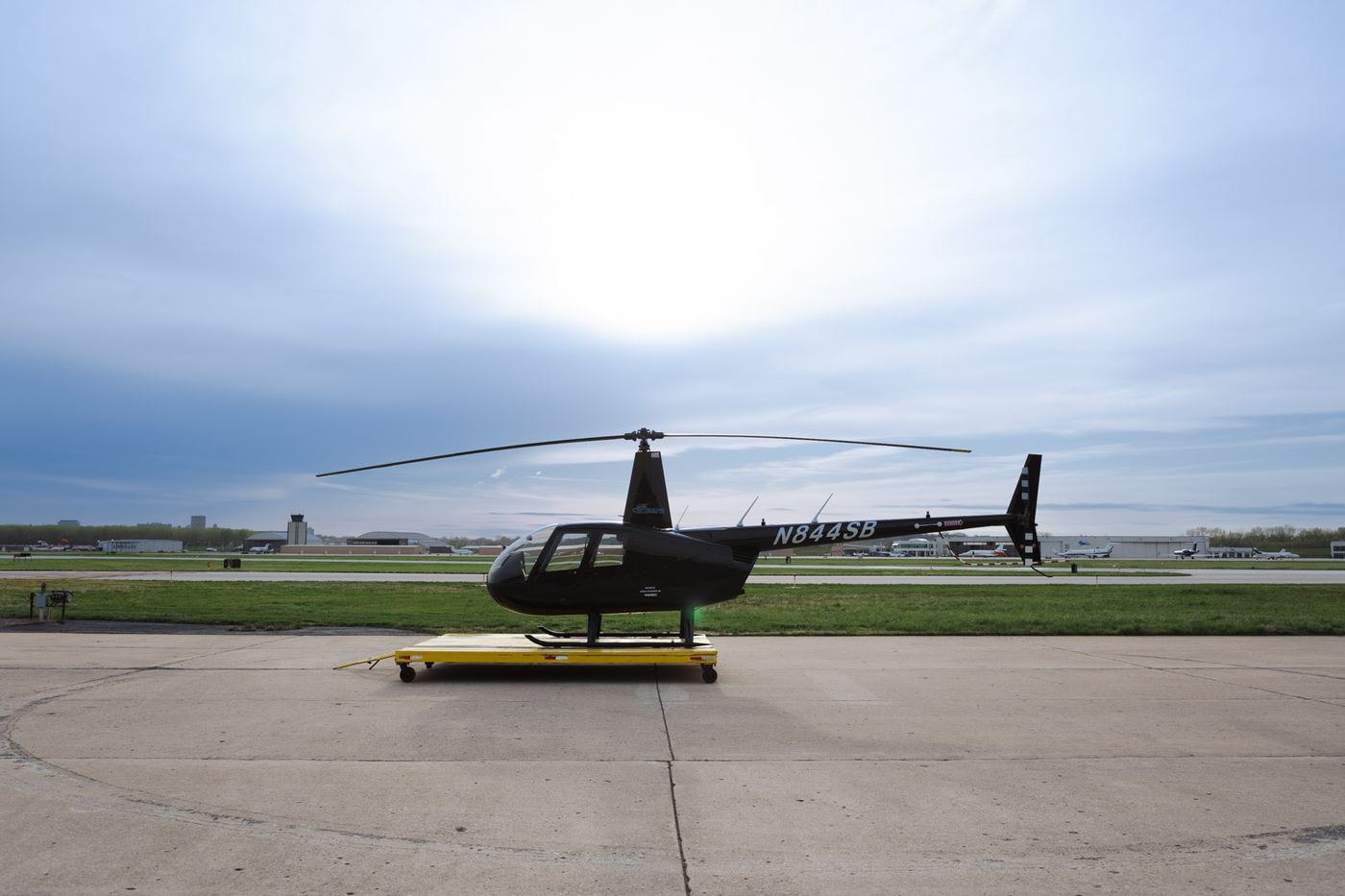 Black Robinson tour helicopter on the pad at a Kansas City area airport before a sightseeing flight